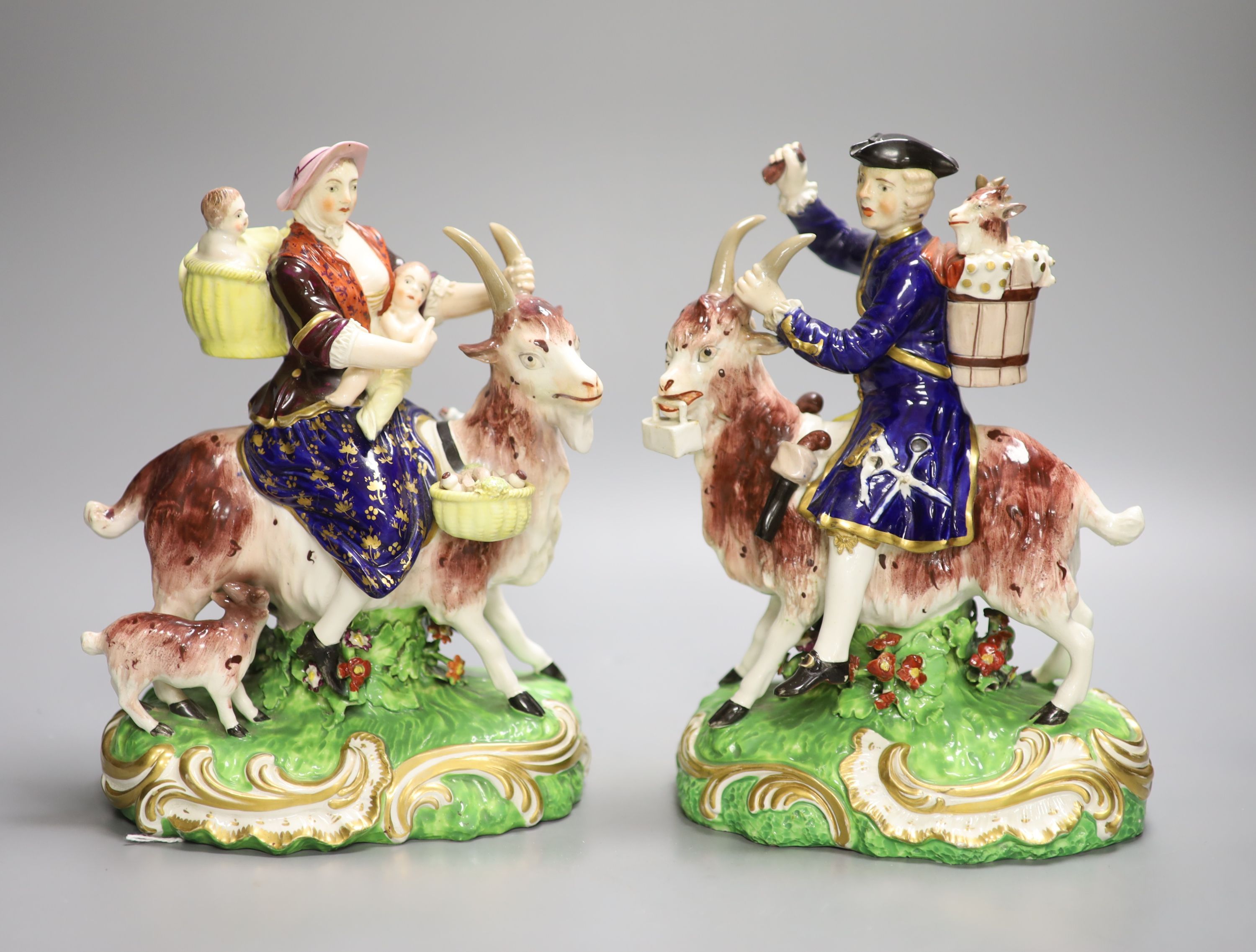 A pair of Derby figures, Welsh Tailor and Companion figures both figures seated on a goat,